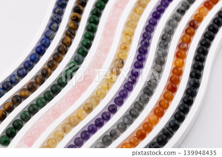 Colorful Gemstone Bead Strands Arranged in Curved Rows Colorful Gemstone Bead Strands Arranged in Curved Rows 139948435