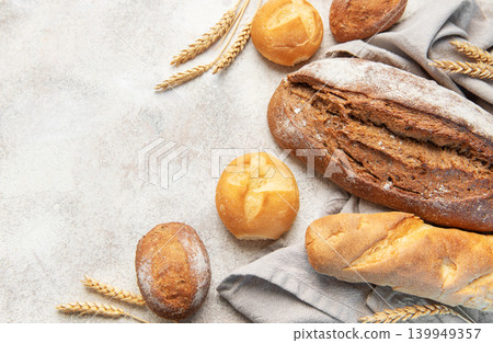 Fresh baked bread, rolls, wheat grain on concrete 139949357