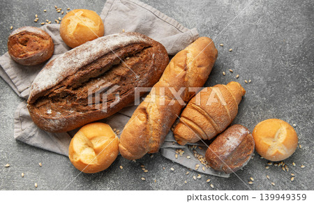 Freshly baked bread assortment on rustic grey background Freshly baked bread assortment on rustic grey background 139949359