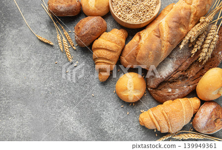 Assortment of fresh bread and pastries on gray background Assortment of fresh bread and pastries on gray background 139949361