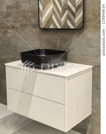 Modern bathroom vanity with black square vessel sink and chevron tile mirror Modern bathroom vanity with black square vessel sink and chevron tile mirror 139949634