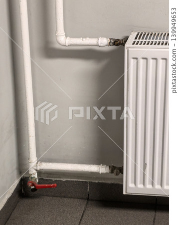 Detail View of Radiator Connection with Metal Pipes and Valve Detail View of Radiator Connection with Metal Pipes and Valve 139949653