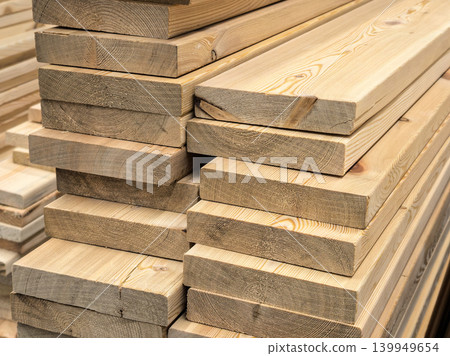 Stacked Pine Lumber Planks Close-up for Construction Stacked Pine Lumber Planks Close-up for Construction 139949654