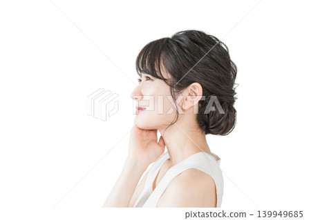 Profile view of a beautiful Asian woman with flawless skin applying skincare products (Beauty, spa, skincare image) Profile view of a beautiful Asian woman with flawless skin applying skincare products (Beauty, spa, skincare image) 139949685