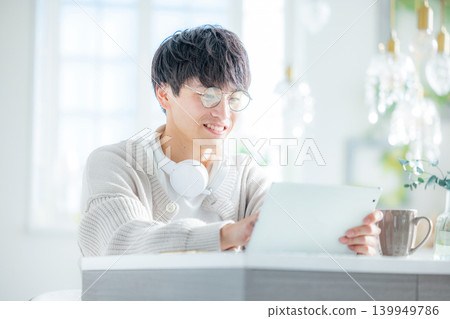 一名男子正在使用平板電腦閱讀。 139949786