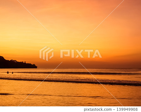 Sunset over Jimbaran Beach with silhouetted figures on shoreline, Bali, Indonesia 139949908
