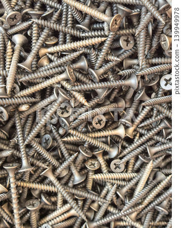 Close Up Pile of Metal Screws and Fasteners Background Texture 139949978
