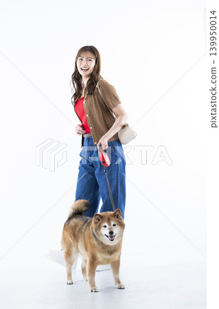 A young woman walking with a Shiba Inu on a white background 139950014