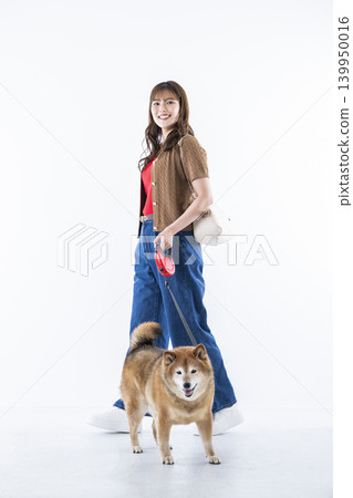 A young woman walking with a Shiba Inu on a white background A young woman walking with a Shiba Inu on a white background 139950016