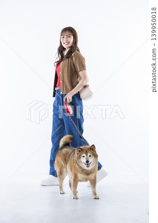 A young woman walking with a Shiba Inu on a white background 139950018
