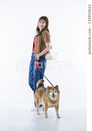 A young woman walking with a Shiba Inu on a white background 139950022