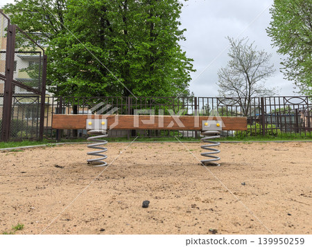 Wooden Spring Seesaw on Playground Close Up Wooden Spring Seesaw on Playground Close Up 139950259