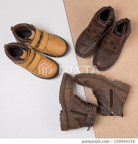 Flat lay composition of various leather men's shoes on white and craft background, top view. Flat lay composition of various leather men's shoes on white and craft background, top view. 139950339