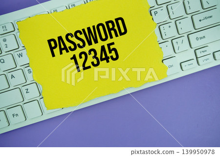 Yellow paper with text "Password 1234" placed on a white keyboard Yellow paper with text "Password 1234" placed on a white keyboard 139950978