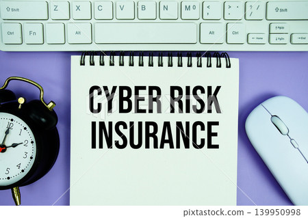 Notepad with the text "Cyber Risk Insurance" with white keyboard, wireless mouse and alarm clock on purple background Notepad with the text "Cyber Risk Insurance" with white keyboard, wireless mouse and alarm clock on purple background 139950998