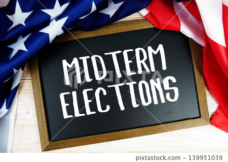 American flag with blackboard "Midterm Elections" on wooden background American flag with blackboard "Midterm Elections" on wooden background 139951039