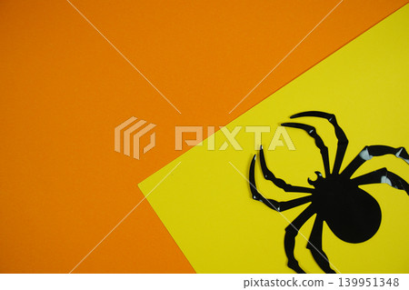 Black spider positioned on a vibrant yellow and orange background a bold and simple Halloween-themed design for seasonal graphics, invitations, or decor. Black spider positioned on a vibrant yellow and orange background a bold and simple Halloween-themed design for seasonal graphics, invitations, or decor. 139951348