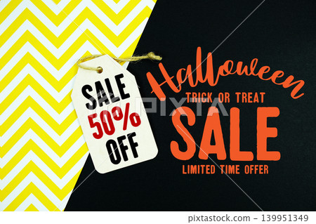 Halloween sale graphic and Gift tag offering 50% off with twine resting on black and yellow chevron background for seasonal promotions and retail marketing. Halloween sale graphic and Gift tag offering 50% off with twine resting on black and yellow chevron background for seasonal promotions and retail marketing. 139951349