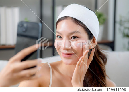 Beauty young asian woman happy take selfie with smartphone for check skin in living room. Beauty young asian woman happy take selfie with smartphone for check skin in living room. 139951698
