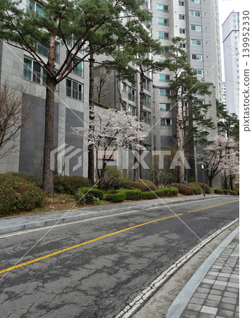 It is an apartment complex with a road. 139952330