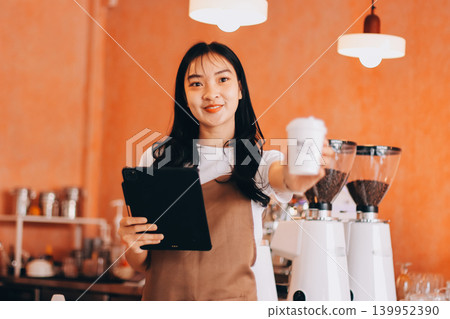 Young woman at barista school learning how to make espresso coffee. 139952390