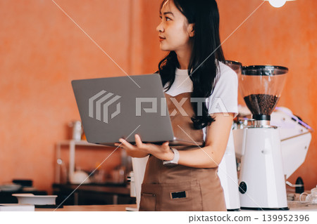 Young woman at barista school learning how to make espresso coffee. Young woman at barista school learning how to make espresso coffee. 139952396
