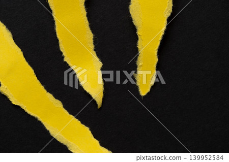Torn yellow drawing paper on a black background 139952584