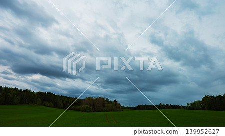 Dangerous storm clouds loom over the fields, creating an ominous atmosphere. Dangerous storm clouds loom over the fields, creating an ominous atmosphere. 139952627