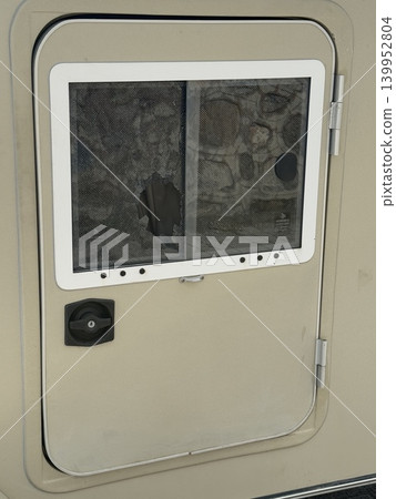 Broken screen door with visible tear, rustic background texture, outdoors conceptual theme Broken screen door with visible tear, rustic background texture, outdoors conceptual theme 139952804