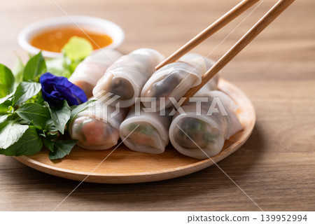 Thai Fresh Spring Rolls with Herbs and Vegetables eating with spicy dipping sauce Thai Fresh Spring Rolls with Herbs and Vegetables eating with spicy dipping sauce 139952994