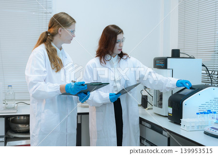 Diverse Scientists Conduct Biotechnology Research in Modern Laboratory Diverse Scientists Conduct Biotechnology Research in Modern Laboratory 139953515