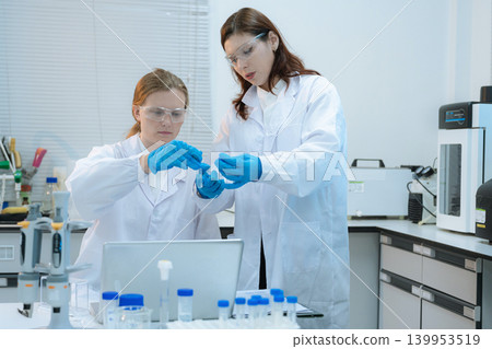 Diverse Scientists Conduct Biotechnology Research in Modern Laboratory 139953519