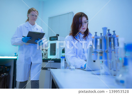 Diverse Scientists Conduct Biotechnology Research in Modern Laboratory Diverse Scientists Conduct Biotechnology Research in Modern Laboratory 139953528