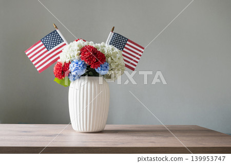 Patriotic flower bouquet with American flags in white vase on table Patriotic flower bouquet with American flags in white vase on table 139953747