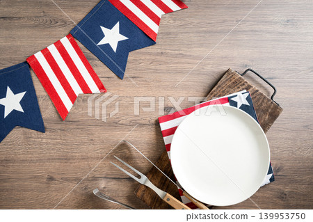 Fourth of July barbecue table setting with American patriotic decorations Fourth of July barbecue table setting with American patriotic decorations 139953750