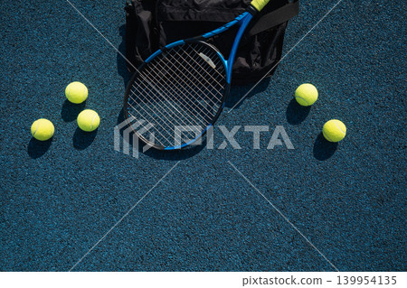 Tennis racket and balls on blue court flat lay with copy space 139954135