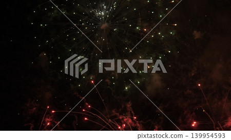 Sky Fireworks Sparkle. Vivid Fireworks Explode Across Broad Night Sky Creating Vibrant Displays. Spectacular Fireworks Illuminate Evening Sky With Dazzling Colors Above Open Fields 139954593