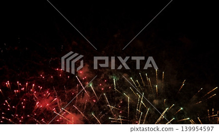 Vibrant Fireworks Display. Colorful Explosions Fill Night Sky. Bright Fireworks Burst Across Dark Evening Sky. Spectacular Fireworks Illuminate Black Night With Warm Colors 139954597