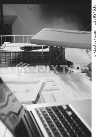 Professional photo of a person's hands reviewing a contract or legal document on a desk, for concepts of business, finance, and legal affairs Professional photo of a person's hands reviewing a contract or legal document on a desk, for concepts of business, finance, and legal affairs 139954630