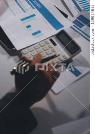 Professional photo of a person's hands reviewing a contract or legal document on a desk, for concepts of business, finance, and legal affairs Professional photo of a person's hands reviewing a contract or legal document on a desk, for concepts of business, finance, and legal affairs 139954652