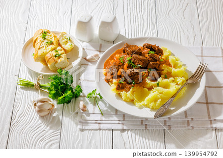 slow cooked beef meat stew served with mashed potatoes slow cooked beef meat stew served with mashed potatoes 139954792