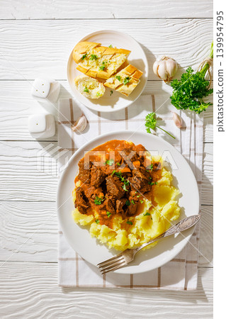slow cooked beef meat stew served with mashed potatoes slow cooked beef meat stew served with mashed potatoes 139954795