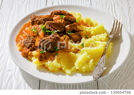 slow cooked beef meat stew served with mashed potatoes 139954798