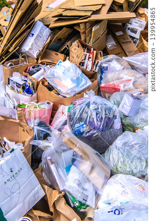 Yokohama, Japan: Collection day for used paper and textiles. Cardboard and paper piled high...and in the confusion...plastic bottles? = Yokohama City Yokohama, Japan: Collection day for used paper and textiles. Cardboard and paper piled high...and in the confusion...plastic bottles? = Yokohama City 139954865