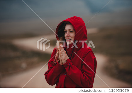 Young woman portrait in cold wind in mountains 139955079