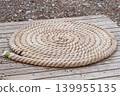 Folded vintage sea rope lies on seashore. Marina seascape. 139955135