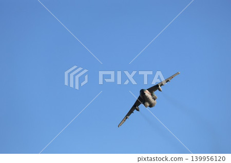 A Japanese Self-Defense Forces transport plane circles in the blue sky. A Japanese Self-Defense Forces transport plane circles in the blue sky. 139956120