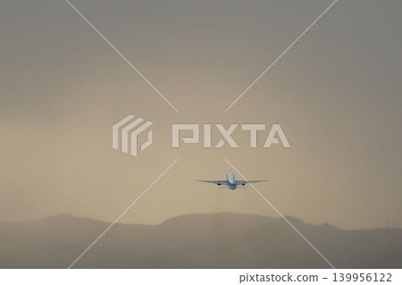 An airplane takes off into a sky filled with clouds. An airplane takes off into a sky filled with clouds. 139956122
