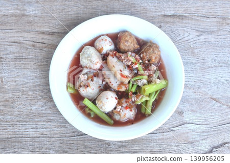 boiled fish and shrimp meatball with morning glory topping mashed pork in spicy red sauce tom yum soup on bowl boiled fish and shrimp meatball with morning glory topping mashed pork in spicy red sauce tom yum soup on bowl 139956205