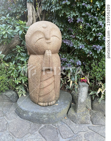 The calming Jizo statue at Hase-dera Temple in Kamakura: A healing spot with a serene expression. The calming Jizo statue at Hase-dera Temple in Kamakura: A healing spot with a serene expression. 139956209